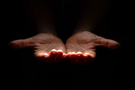 Two hands with open palms turned up, offering or giving something, a handful.