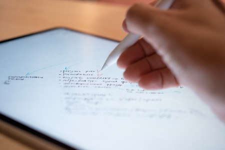 Plan and make notes by hand on a digital tablet, lists and flowchartsの写真素材