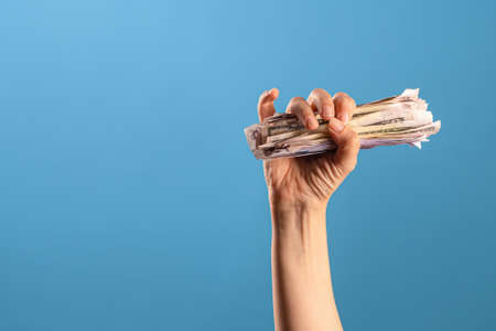Earn money, get a good revenue. A female hand and a lot of cash,の写真素材