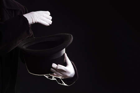 Hand gestures. illusionist holds a hat in his hands and shows magic and tricks.の写真素材