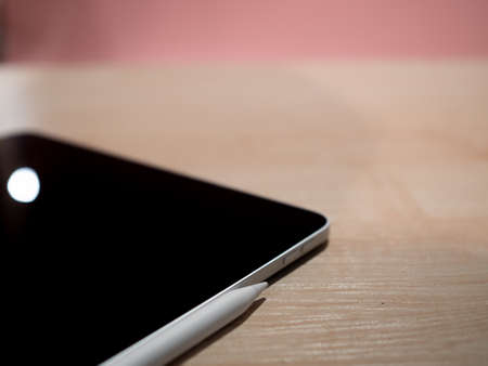 A thin tablet computer with a stylus, a tool for work and digital art,の写真素材