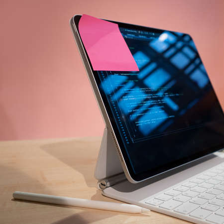 A laptop with a reminder on the corner of the monitor. Time management and schedule in the work of a...