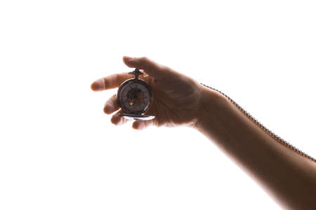 Vintage pocket watch in a womans hand. Time passes, the moment has come, the concept of time and time management. isolated on white, contrast lightの写真素材