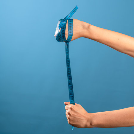 Lose weight, get rid of excess weight, a call to engage in health. A female hand holds a centimeter...