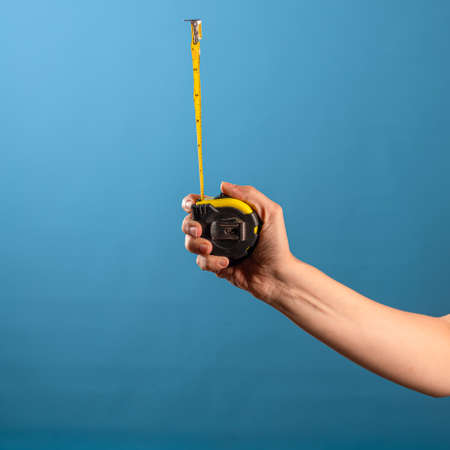 Measure it, a yellow construction tape measure to measure the length of something. Roulette with a...