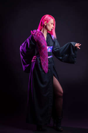 Fashion of the future, multicultural outfit with elements printed on a 3D printer. Stylish young woman with pink hair and black lips in a gothic cyber image, 3D printing and a classic kimonoの写真素材