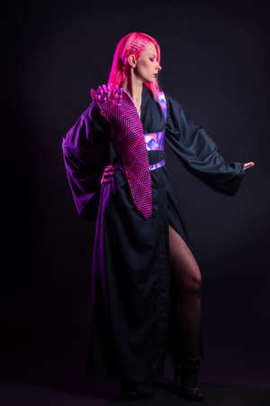 Fashion of the future, multicultural outfit with elements printed on a 3D printer. Stylish young woman with pink hair and black lips in a gothic cyber image, 3D printing and a classic kimonoの写真素材