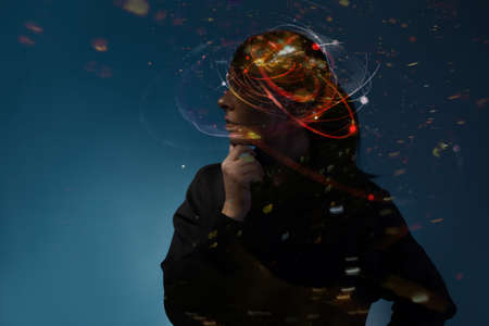Creative work, concept. Young thoughtful woman, portrait in profile, silhouette on a dark blue background. Thoughts in the head , cognitive processes in the brain , like a sketchの写真素材