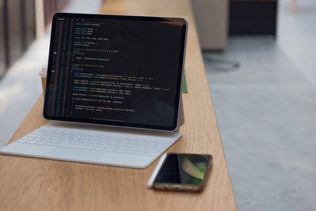 freelancers workplace. A thin mobile laptop on a table in a coworking or other public space. low...