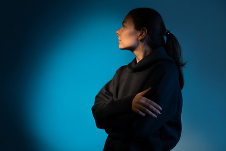 Hard light, face in partial shade. Work of thought, concept. The birth of an idea, a cognitive process in the mind. Young woman portrait side viewの写真素材