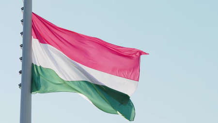 Hungary, flag is fluttering in the wind photo on the background of the sky, outdoors. National flagの写真素材