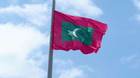 Maldives, flag is fluttering in the wind photo on the background of the sky, outdoors. National flagの写真素材