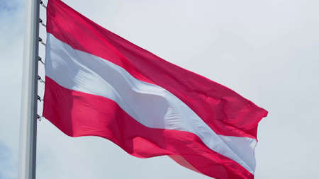 Austria, flag is fluttering in the wind photo on the background of the sky, outdoors. National flagの写真素材