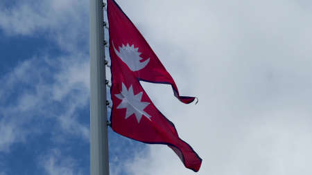 Nepal, flag is fluttering in the wind photo on the background of the sky, outdoors. National flagの写真素材