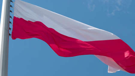 Poland, flag is fluttering in the wind photo on the background of the sky, outdoors. National flagの写真素材