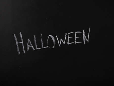 Halloween,hand chalked inscription on blackboard, copy space, themed posterの写真素材