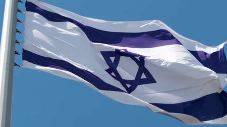 Israel, flag is fluttering in the wind photo on the background of the sky, outdoors. National flagの写真素材