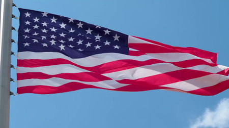 USA, flag is fluttering in the wind photo on the background of the sky, outdoors. National flagの写真素材
