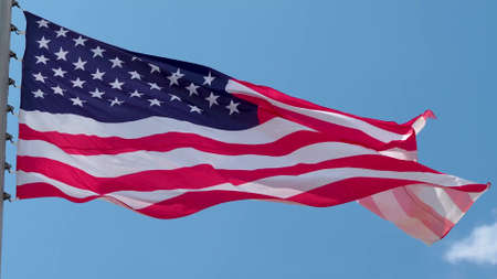 USA, flag is fluttering in the wind photo on the background of the sky, outdoors. National flagの写真素材