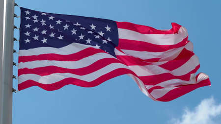 USA, flag is fluttering in the wind photo on the background of the sky, outdoors. National flagの写真素材