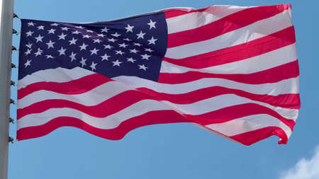 USA, flag is fluttering in the wind photo on the background of the sky, outdoors. National flagの写真素材