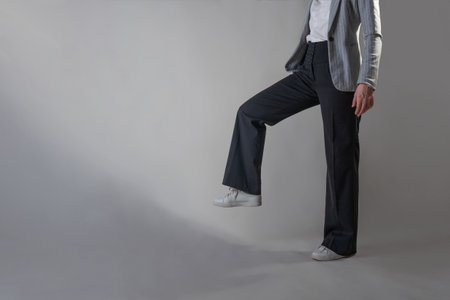 A young businesswoman in the image of a giant is trampling on something, an empty space for your design.の写真素材