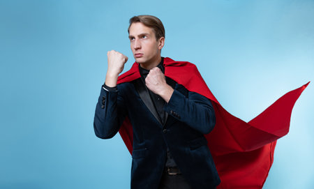 superhero is ready to fight, a man in a business suit and a red cape. charismatic and successful business hero.の写真素材