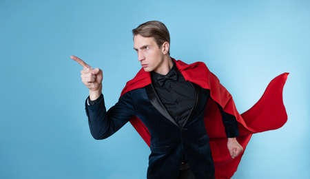 superhero is ready to fight, a man in a business suit and a red cape. charismatic and successful business hero.の写真素材