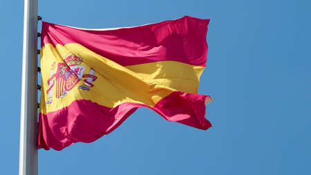 Spain, flag is fluttering in the wind photo on the background of the sky, outdoors. National flagの写真素材