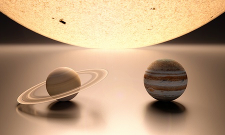 A rendered comparison of the Sun and the Planets Jupiter and Saturn.の写真素材