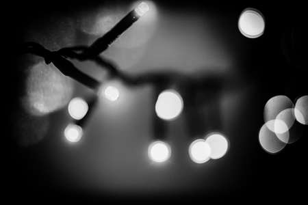 small blurry Christmas lights glowing in the darkの写真素材