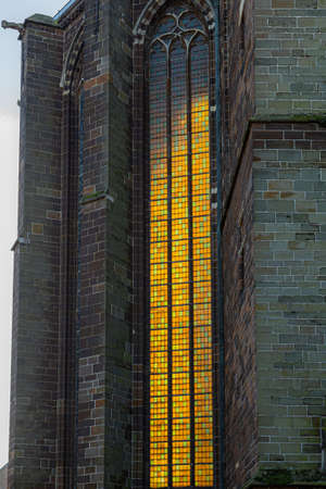 gothic cathedral side window lighted by back sunlightの写真素材