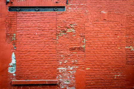 brick wall of a house painted redの写真素材