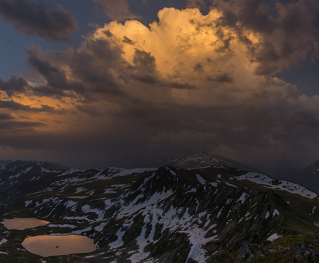 Sunset high in mountain. Dramatic overcast sky. Caucasus mountains. Karachay-Cherkessia. Russia.の写真素材