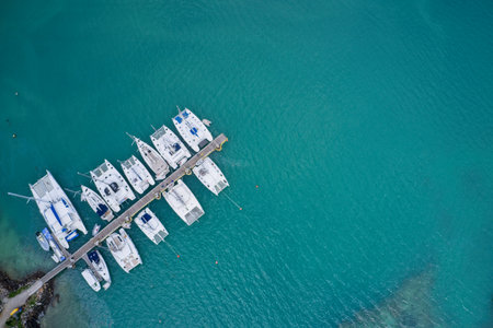 Drone field of view of boats moored in harbour in turquoise blue water Praslin Seychelles.の写真素材