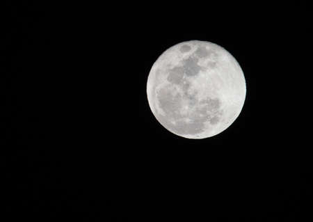 Closeup of bright full moon in Ecuador showing fine detail of lunar surface.の写真素材