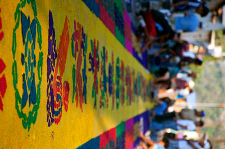 Street screen of locals producing alfombra, sawdust carpets with colorful designs for Semana Santa, Easter on the streets of Lake Atitilan, Guatemala.の写真素材