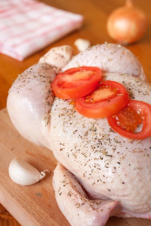 Preparation of a provencal chicken, with aromatic herbs, garlic, onions and tomatoesの写真素材