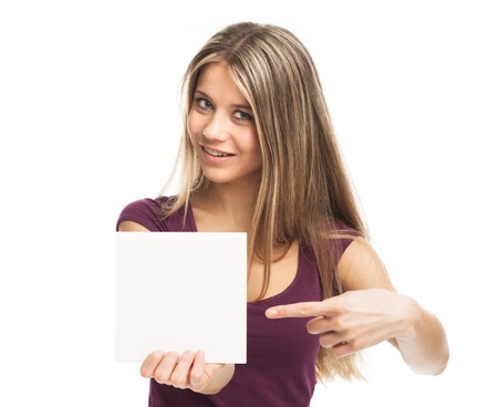 Smiling young woman showing a white card, on whiteの写真素材