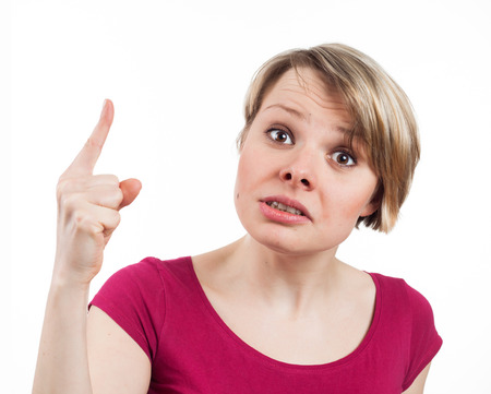 Close up view of a young woman scolding somebody, isolated on whiteの写真素材
