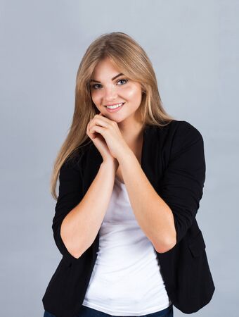 Portrait of a charming young woman, isolated on greyの写真素材