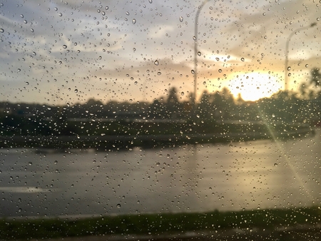 Raindrops on car window taken at sunset outside Colombo, Sri Lankaの写真素材