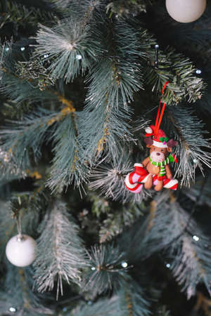 A Christmas decoration featuing a reindeer on a candy cane hanging from a Christmas treeの写真素材