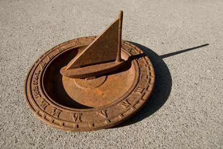 An old steel nautical sundial in the shape of a sailboat, with a delicate rusty patina. の写真素材