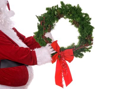 Santa Claus holding a wreath in his white gloved handsの写真素材
