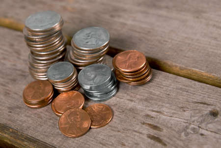 Coins in stacks on a picnic tableの写真素材