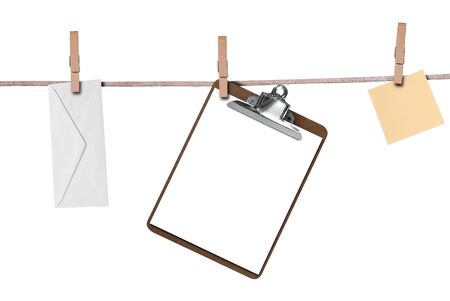 Envelope,clipboard and a post-it note hanging on a clothesline isolated on whiteの写真素材