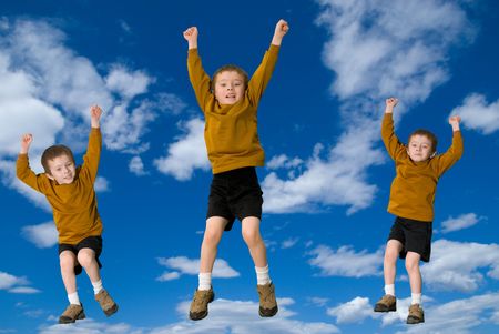 Young attractive boys jumping with a sky backgroundの写真素材