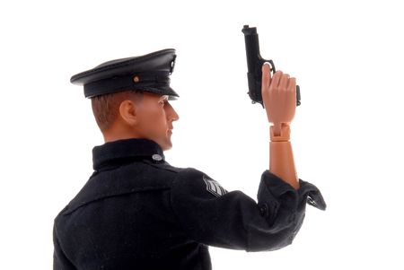 plastic toy police officer doll with a drawn pistolの写真素材