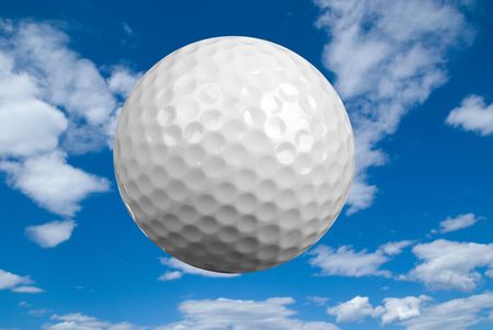 Golf ball close-up isolated over a cloudy sky background の写真素材